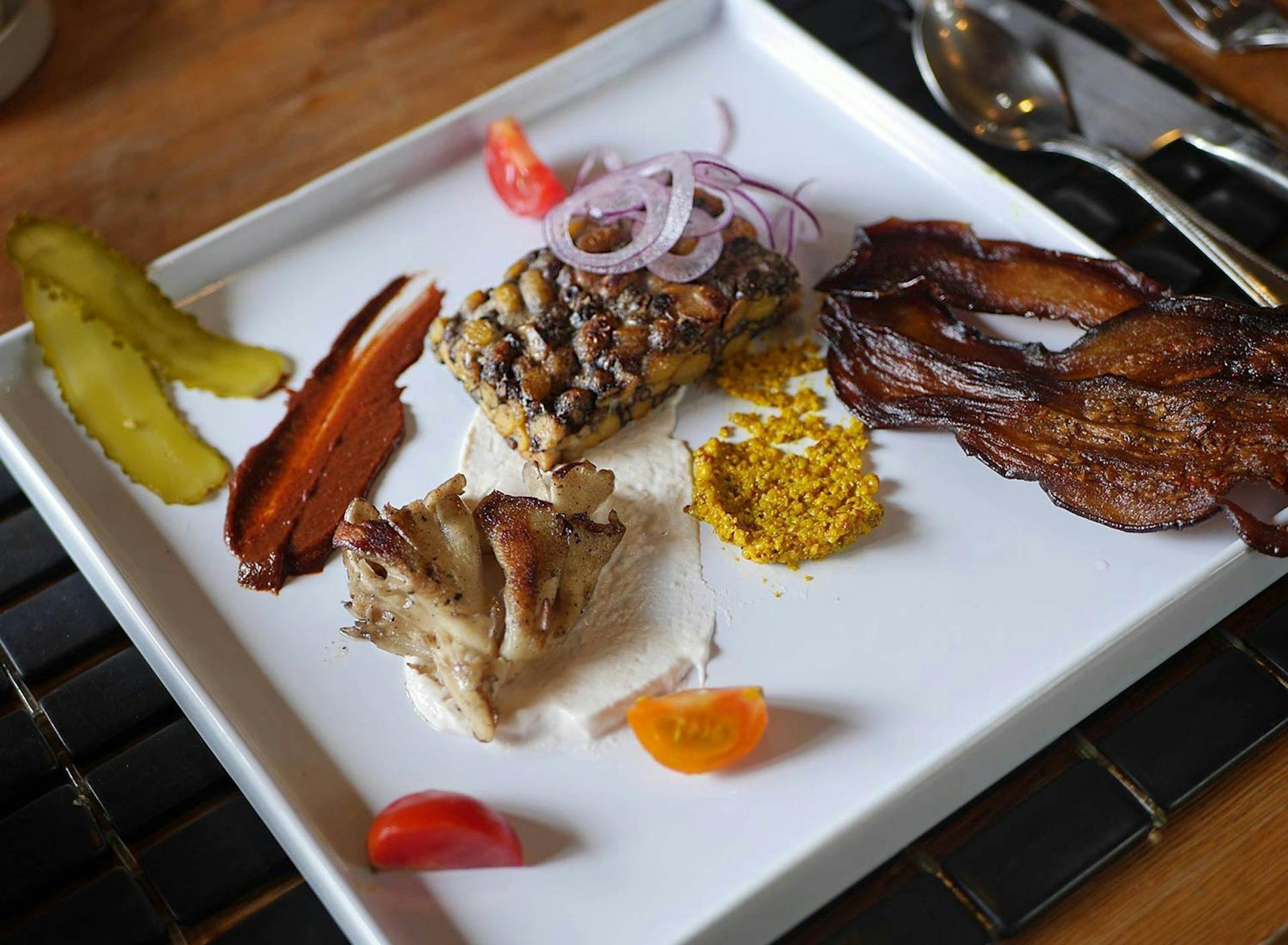 Food Lab at SHO: vegan gastronomy in a cold climate | deconstructed burger: pan-fried siberian pea & soy bean tempeh, mayo with lacto-fermented horseradish, dijon mustard with broccoli seeds & dandelion winter, buffalo berry & black garlic ketchup, grilled maitake mushroom, eggplant bacon, lacto-fermented sour dill pickles - vegan, homemade, most ingredients from the farm